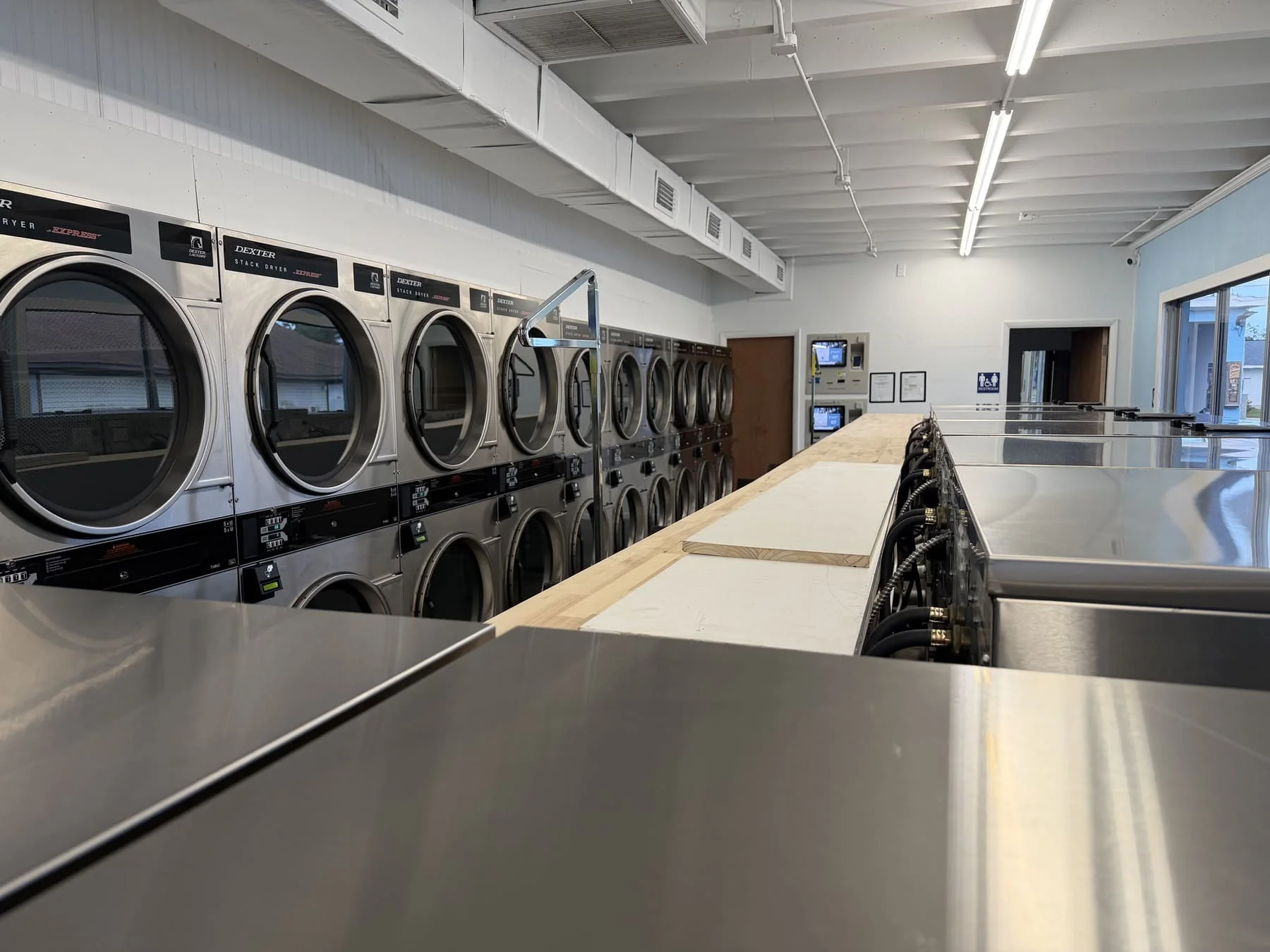 Ridgewood Laundry interior with rows of commercial laundry machines